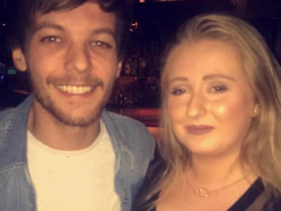 Louis poses with a fan in The Alchemist