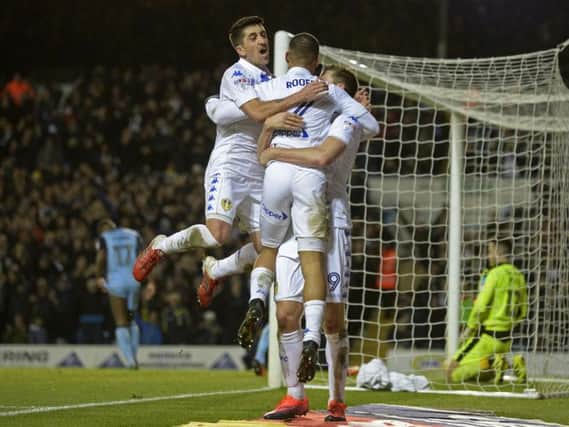 Chris Wood, Kemar Roofe and Pablo Hernandez embrace after Leeds's third