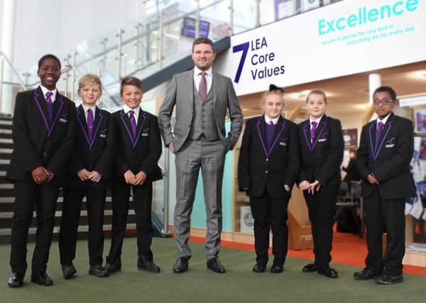 LEADER: Newly appointed principal Chris Stokes with pupils.