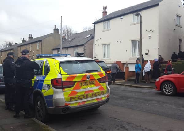 Armed police officers arrive at the home of Mohammed Yassar Yaqub in the Crosland Moor area of Huddersfield.