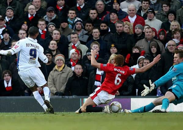 Leeds United's Jermaine Beckford (left) scores what proved to be the winning goal during the FA Cup Third Round match at Old Trafford in January 2010. Picture: Martin Rickett/PA.