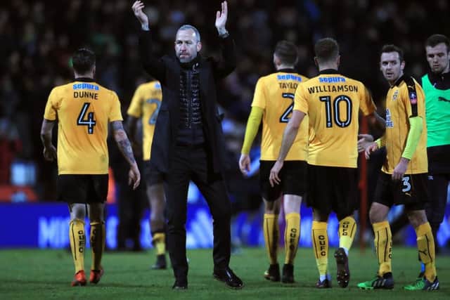 Cambridge United manager Shaun Derry applauds the fans after defeat to Leeds United on Monday night. Picture: Mike Egerton/PA