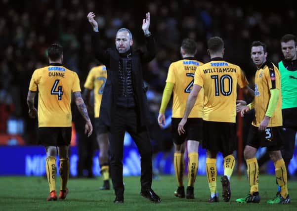 Cambridge United manager Shaun Derry applauds the fans after defeat to Leeds United on Monday night. Picture: Mike Egerton/PA
