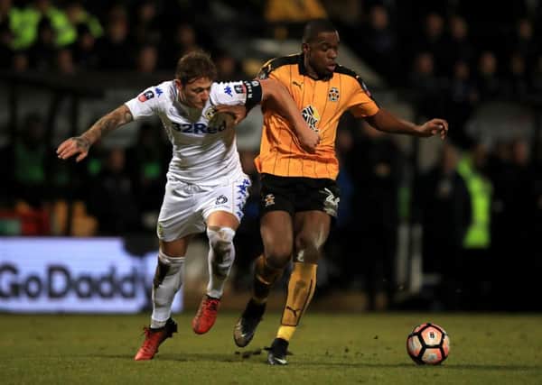 Cambridge's Uche Ikpeazu and Leeds United's Liam Cooper (left) battle for the ball on Monday night. Picture: Mike Egerton/PA
