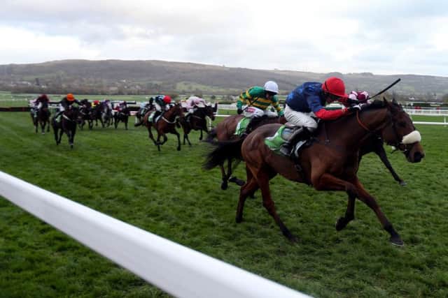 Old Guard ridden by Harry Cobden (red cap) on their way to victory in the StanJames.com Greatwood Hurdle during day three of The Open at Cheltenham in November 2015.