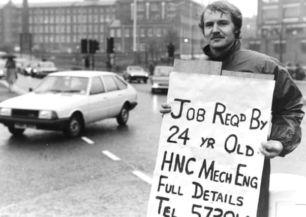 Leeds, 1980s  From the traffic island near the International Pool in Leeds, Frank Howarth holds aloft his sign asking for work ---- in the hope that some passing driver can solve his dilemma.