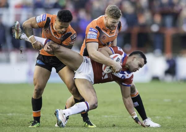 Wakefield Trinity's Mason Caton-Brown is upended in the recent pre-season game with Castleford Tigers.