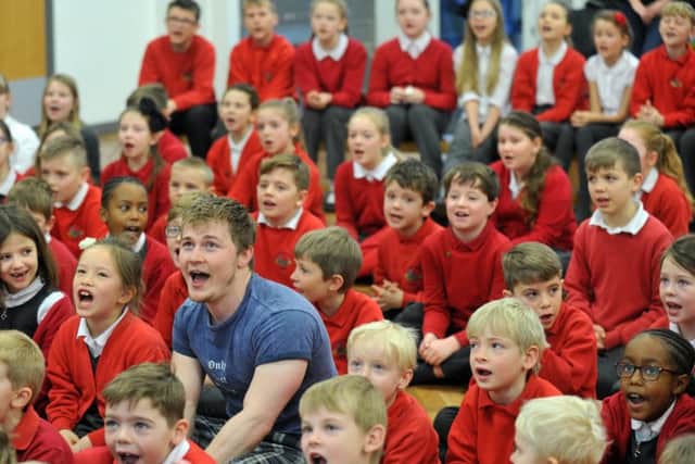 Curtis T Johns singing with pupils from Barwick-in-Elmet Church of England Primary School. PIC: Gary Longbottom