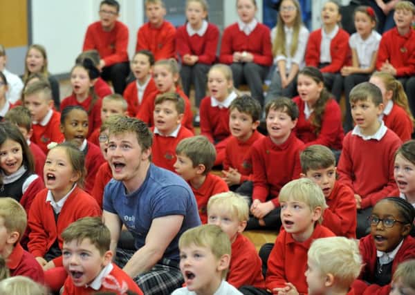 Curtis T Johns singing with pupils from Barwick-in-Elmet Church of England Primary School. PIC: Gary Longbottom
