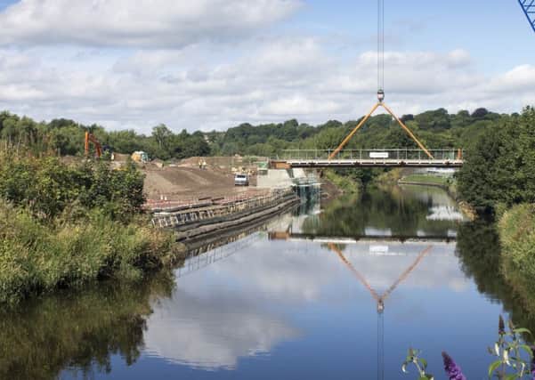 PROJECT: The bridge at Kirkstall Forge being lowered into place.
