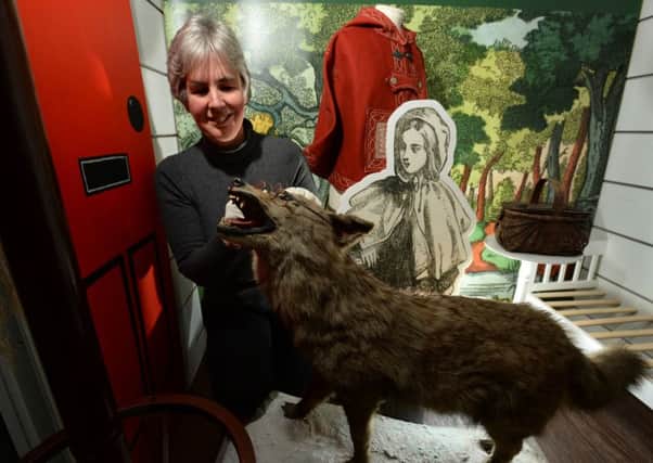 Kitty Ross, curator of Leeds Histories, putting the finishing touches to the Little Red Riding Hood display. PIC: Bruce Rollinson