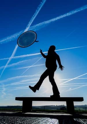 Date:5th January 2016. Picture James Hardisty.
 Pictured A member of the pubic plays Noughts and Crosses in the sky under a winter sun at the Yorkshire Sculpture Park, Bretton, Wakefield.