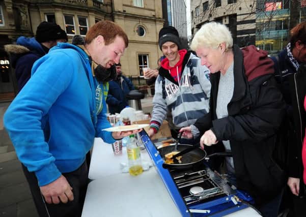 A WELCOME MEAL: The Homeless Leeds Support Group serving up cooked breakfasts in City Square. PIC: Simon Hulme