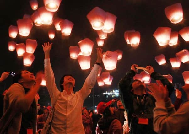 Hundreds of people release lanterns into the air, in hopes of good fortune and prosperity at the traditional lantern festival during the Chinese New Year in the Pingxi district of New Taipei City, Taiwan, Monday, Feb. 22, 2016. The lantern festival starts 15 days after the Chinese Lunar New Year and falls on Feb. 22, this year. (AP Photo/Chiang Ying-ying)