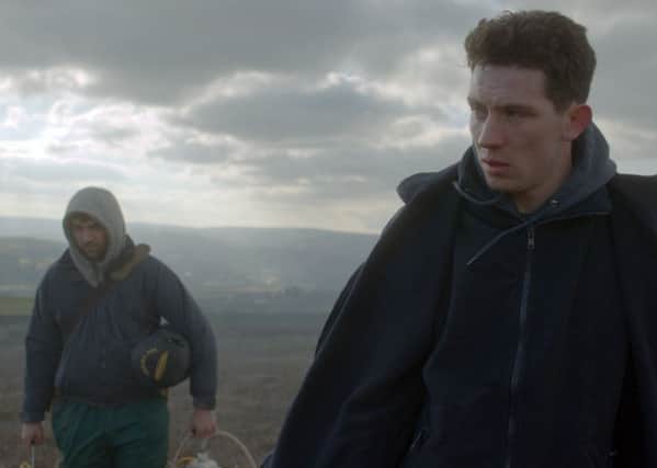 Alec Secareanu as Gheorghe Ionescu and Josh O'Connor as Johnny Saxby in God's Own Country.