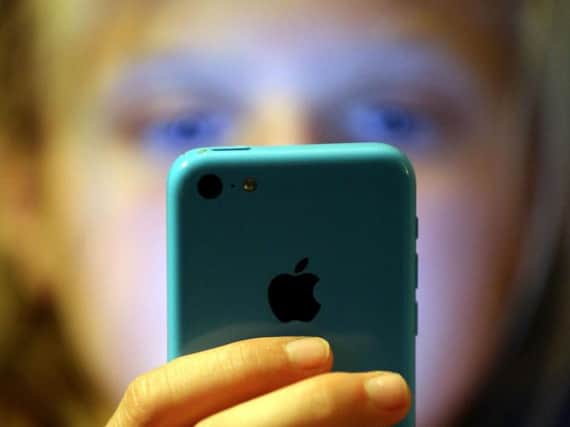 Parents are being urged to talk to their children about the risks posed by social media. Picture: PA