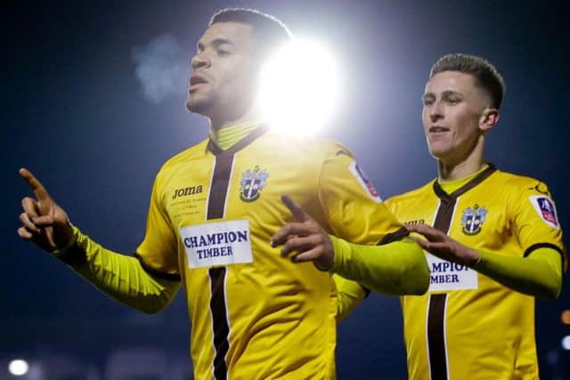 Sutton United's Maxime Biamou celebrates scoring against AFC Wimbledon to set up the fourth round FA Cup tie with Leeds United. PIC: PA