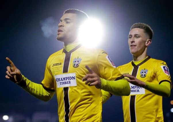 Sutton United's Maxime Biamou celebrates scoring against AFC Wimbledon to set up the fourth round FA Cup tie with Leeds United. PIC: PA