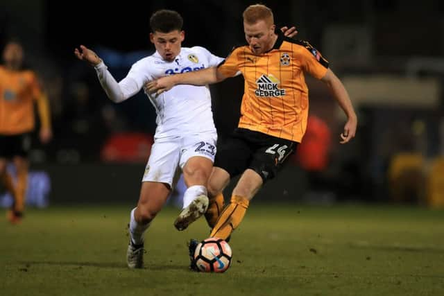 Cambridge's Conor Newton (right) and Leeds United's Kalvin Phillips batle for the ball.