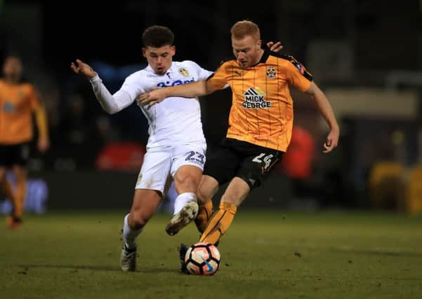 Cambridge's Conor Newton (right) and Leeds United's Kalvin Phillips batle for the ball.