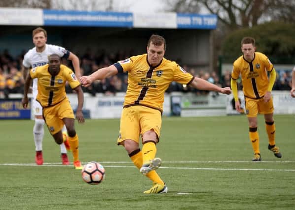 Sutton United's Jamie Collins scores from the penalty spot. PIC: PA