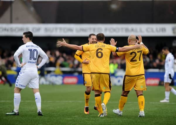 TURNED OVER: 
Sutton's players celebrate at full time.
 
Picture: Jonathan Gawthorpe
