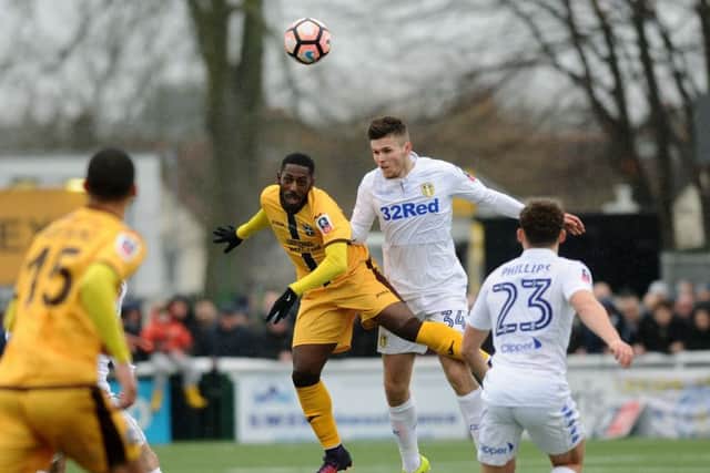 DAY TO FORGET: Leeds United's Paul McKay wins a header from Sutton's Roarie Deacon. Picture: Jonathan Gawthorpe