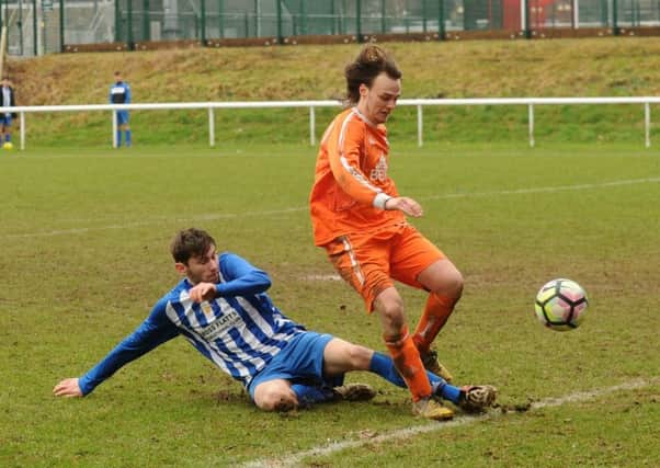 Declan Campbel,l of Beeston Juniors, tackles Leeds Medics' Niall Robinson to knock the ball for a corner. PIC: Steve Riding