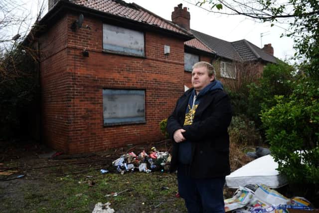 Dom Hodgson outside the empty house attached to his home on Orchard Road, Crossgates.