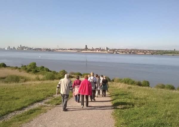 Walkers at the Port Sunlight River Park looking across the Mersey