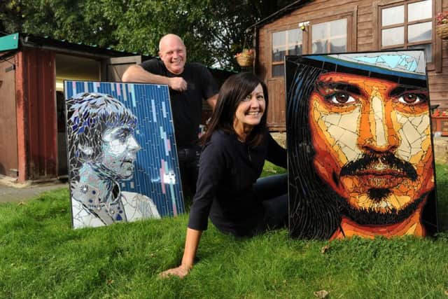 Mosaic artists Allan Butt and Rita Gav with portraits of Paul McCartney and Johnny Depp. PIC: Bruce Rollinson