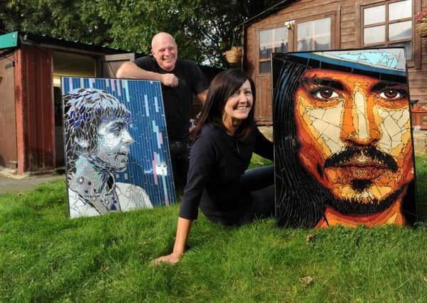 Mosaic artists Allan Butt and Rita Gav with portraits of Paul McCartney and Johnny Depp. PIC: Bruce Rollinson