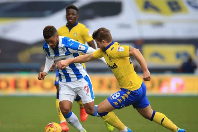 Huddersfield Town's Elias Kachunga (left) and Leeds United's Gaetano Berardi battle for the ball during the Sky Bet Championship match at the John Smith's Stadium, Huddersfield. (Photo: PA)