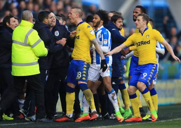 Tempers flare on the touchline as Huddersfield Town manager David Wagner (left) and Leeds United's Pontus Jansson (centre) confront each other during the Sky Bet Championship match at the John Smith's Stadium, Huddersfield. (Photo: PA)