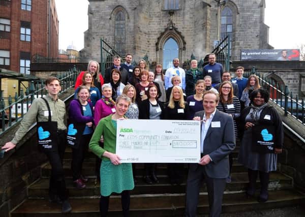 CASH BONUS: Representatives from the Leeds Community Foundation, Asda Foundation and members of the community projects outside the St Georges Centre in Leeds. PIC: Simon Hulme
