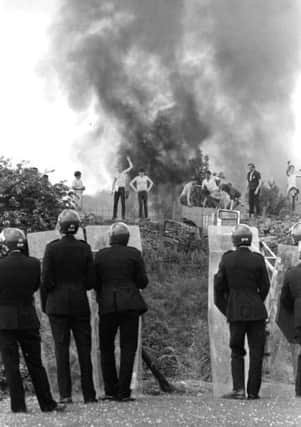 File photo dated 18/06/1984 of riot police watching as pickets face them against a background of burning cars at the Orgreave coke works in Yorkshire during the miners' strike. PRESS ASSOCIATION Photo. Issue date: Sunday December 11, 2016. Home Office files concerning events at the Battle of Orgreave are due to be released next year among a cache of records relating to the 1984 miners' strike. See PA story POLITICS Orgreave. Photo credit should read: PA Wire