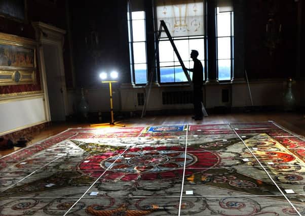 PAINSTAKING: Roger Stark from Harweood House inspects the carpet in the Gallery.