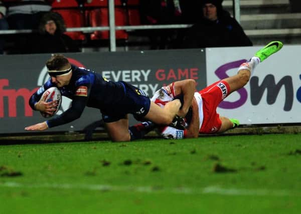 Liam Sutcliffe is tackled by Tommy Makinson.