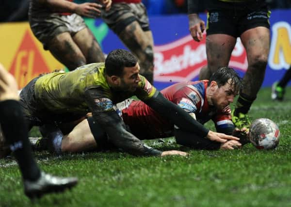 Wakefield's Scott Grix scores the opening try against Hull. PIC: Jonathan Gawthorpe