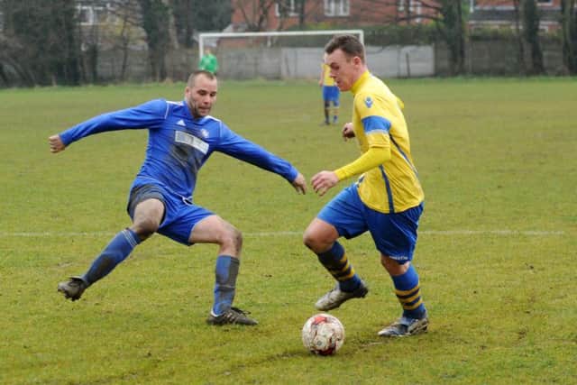 Sam Thorpe, of Drighlington, takes on Alwoodley Res defender Robert Abiss. PIC: Steve Riding