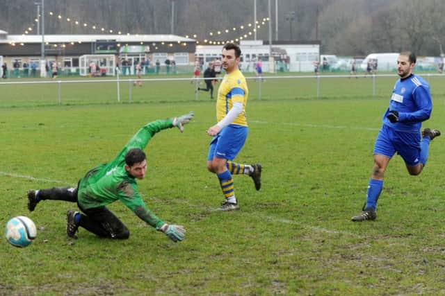 Ryan Rhodes runs through to score for Drighlington past Alwoodley Res goalkeeper Brad Cahill. PIC: Steve Riding