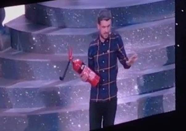 Jack Whitehall on stage in Leeds with a fire extinguisher