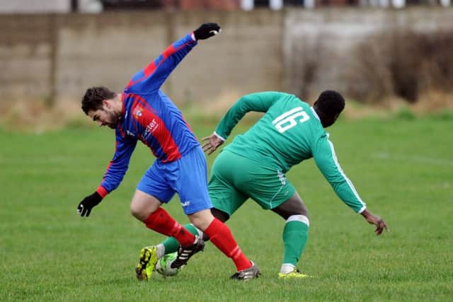 Swillington's Kyle Addison battles with Chapeltown's Andrew Richards. PIC: Jonathan Gawthorpe