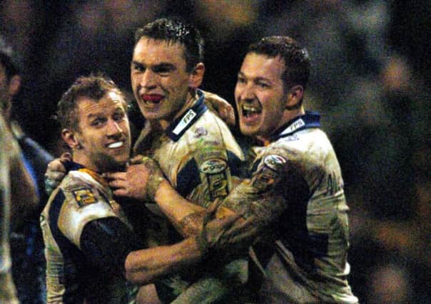 Kevin Sinfield celebrates with Rob Burrow and Danny McGuire after beating Hull in the mud in 2007. PIC: Steve Riding