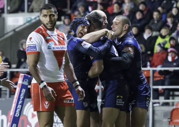 Joel Moon is congratulated by team-mates on scoring against St Helens.