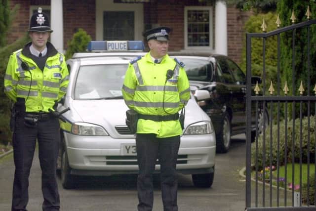 Police stand guard outside the  house  of John Luper in Sandmoor Drive , Alwoodley, at the time of the murder.