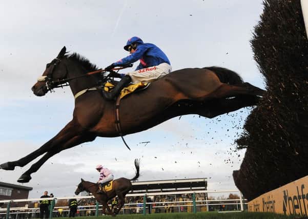 Cue Card and Paddy Brennan on their way to winning the Betfair Steeple Chase at Haydock in November.
