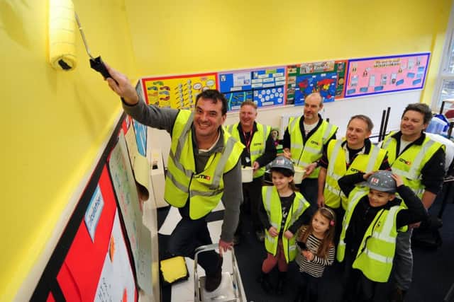 COLOUR ME IMPRESSED: Headteacher Chris Dyson in a new-look classroom with volunteers and pupils. PIC: Simon Hulme