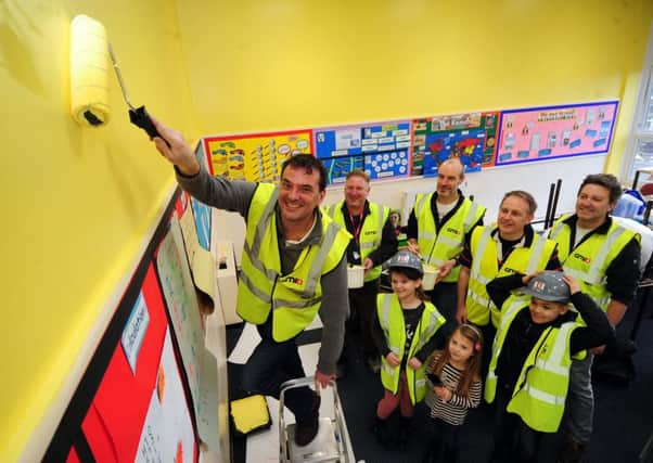 COLOUR ME IMPRESSED: Headteacher Chris Dyson in a new-look classroom with volunteers and pupils. PIC: Simon Hulme