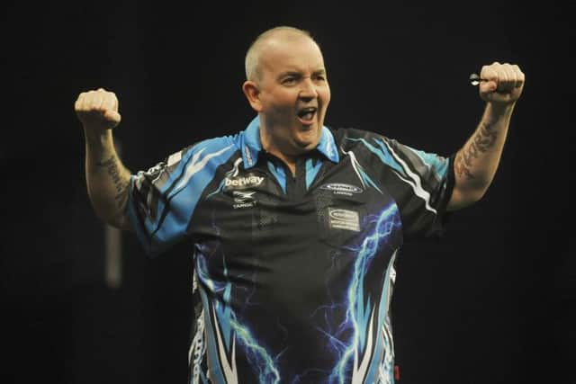 HE'S GOT THE POWER: Former world champion Phil Taylor ceLebrates his 7-4 win over Raymond van Barneveld in the Betway Premier League.